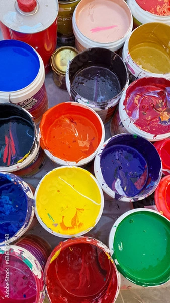 Obraz Multicolored open cans of paint on the street. Variety and brightness of the holiday in Spain