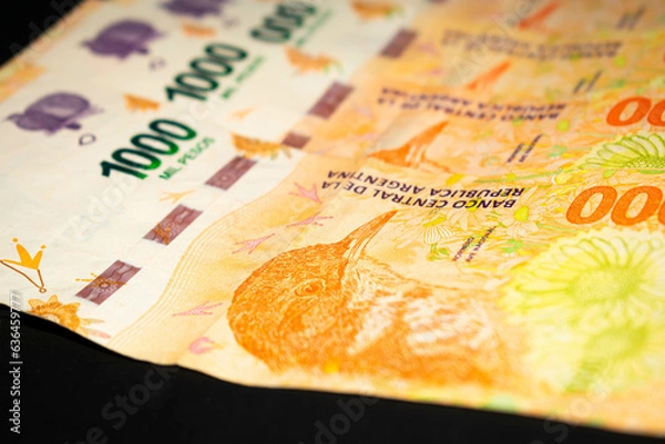 Fototapeta Banknotes of 1000 Argentine pesos, Argentine money, Argentine currency, Argentine pesos. Pile of several thousand Argentine peso bills, one thousand peso bills in cash on black background