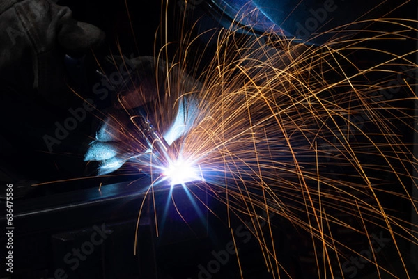 Fototapeta welder, mig or tig welding, craftsman, erecting technical steel Industrial, pretty sparks from weld pistol, steel welder in factory technical