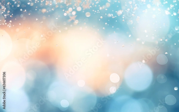 Fototapeta Blurred bokeh background of snowflakes in blue and orange colors.