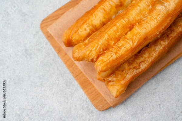 Fototapeta Youtiao or Yu Char Kway is a long golden-brown deep-fried strip of wheat flour dough of Chinese origin