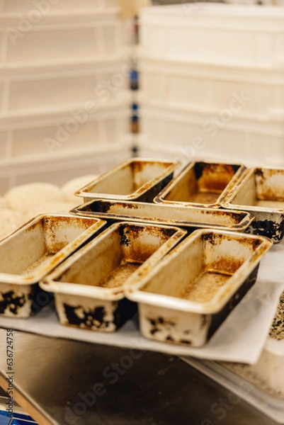 Obraz Rustic empty metal loaf pan tins on tray in professional baking kitchen