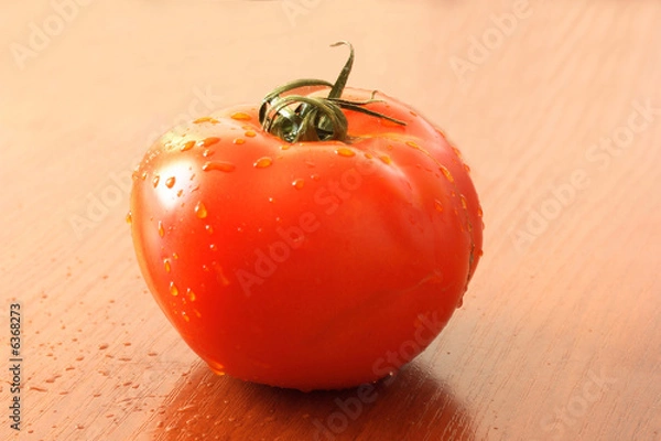 Obraz the red tomato on table.
