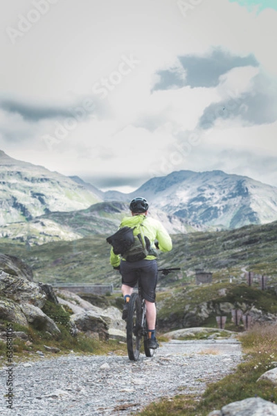 Fototapeta A man riding a mountain bicycle alone