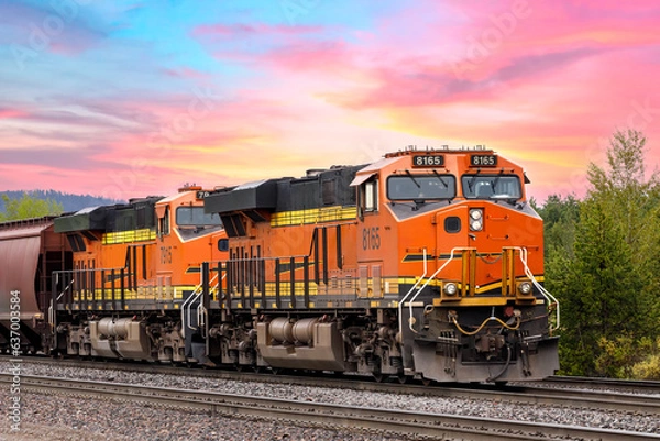 Obraz freight train close to Whitefish, Montana with colorful sky in background