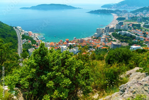 Fototapeta aerial view of the city on the seashore and mountains, panorama of the resorts of Becici and Budva in Montenegro, Adriatic sea, beaches, islands, tourism and travel, summer traveling