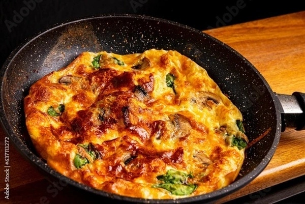 Obraz Freshly-fried pan pizza topped with cheese and mushrooms on a wooden board