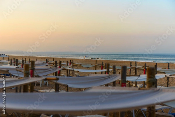 Fototapeta Sunbeds, Beach loungers, Relaxation, Beachside, Umbrellas,