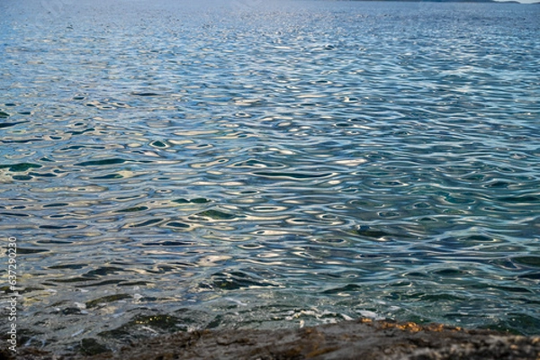 Fototapeta Water surface. Aerial drone view of sea waves. Sun reflection on water surface. 