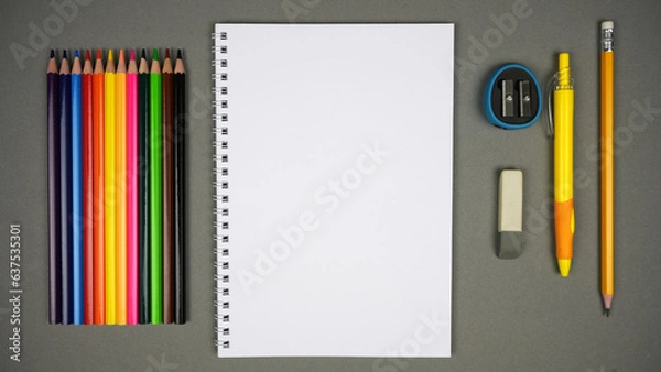 Fototapeta Blank Spiral Notebook With Color Pencils On Grey Background. Stop Motion. Top View