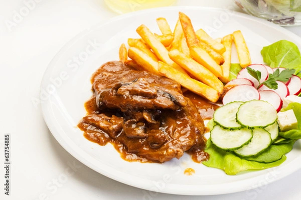 Fototapeta Pork chop with sauce, mushrooms and chips