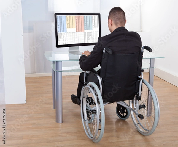 Fototapeta Businessman On Wheelchair Using Computer
