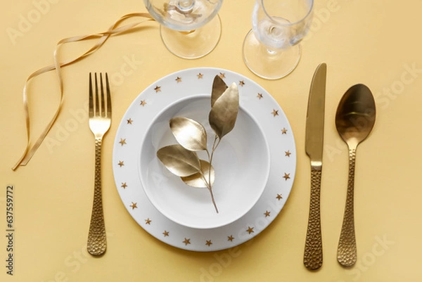 Obraz Elegant table setting with golden leaves and cutlery on yellow table