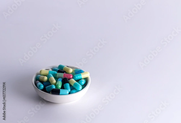 Fototapeta one cup of medicine capsule on white background