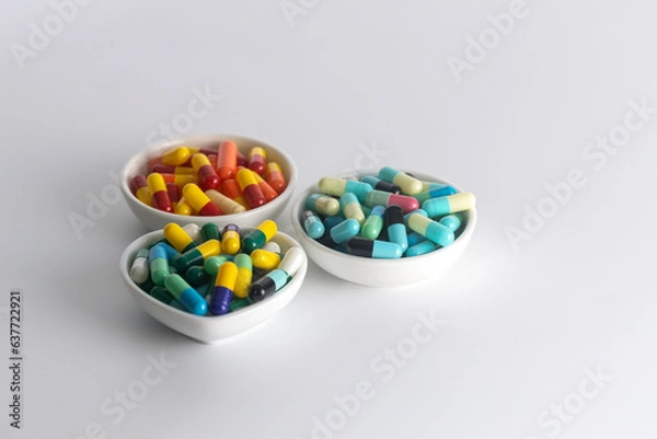 Fototapeta three cup of medicine capsule on white background