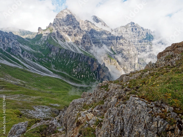Fototapeta Views on the trail to Hoher Burgstall in the Stubai Alps in Austria. Picturesque clouds covered the peaks