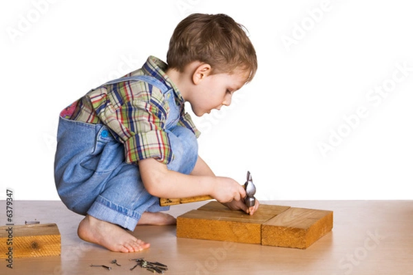 Obraz Kid hammers a hammer in nails