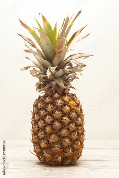 Obraz Single pineapple on wooden board