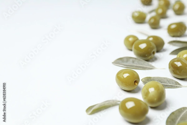 Fototapeta Olives and leaves on white background, space for text