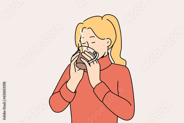 Fototapeta Woman drinks hot tea to keep warm and quench thirst after walk in park in cold winter weather. Girl in sweater holds mug of tea and enjoys taste and aroma of drink made from natural herbs