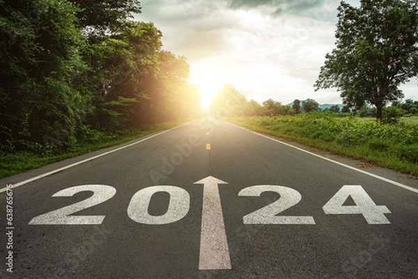 Fototapeta New year 2024 or straightforward concept. Text 2024 written on the road in the middle of asphalt road at sunset.Concept of planning and challenge, business strategy, opportunity ,hope, new life change