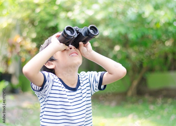 Fototapeta Little boy looking trough a binoculars