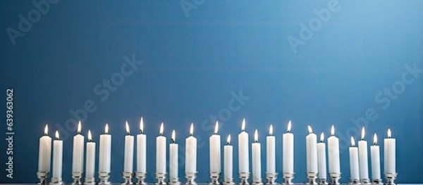 Fototapeta A white menorah adorned with blue and white candles