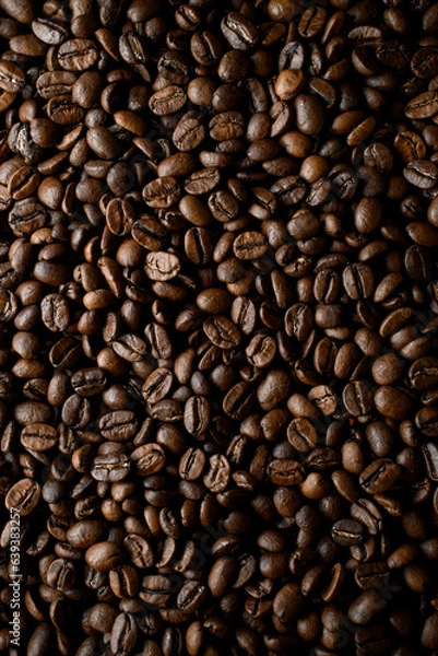 Fototapeta Overhead view of dark brown fresh roasted coffee beans background. Copy space