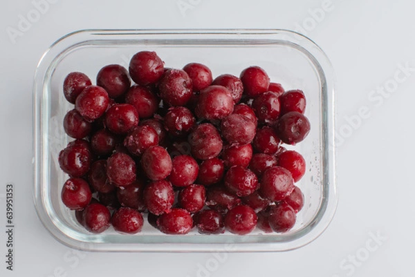 Fototapeta cherry in a glass bowl on the white background, frozen cherry