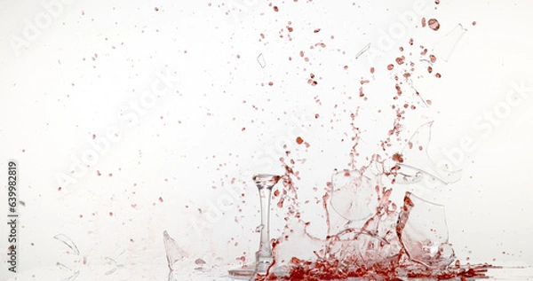 Fototapeta Glass of Red Wine Breaking and Splashing against White Background