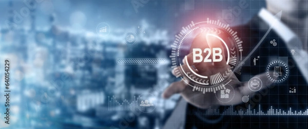Fototapeta Business to business (B2B) market concept. B2B transactions, exchanging of goods and services between organizations. Businessman touching on screen for B2B management by using digital platforms.