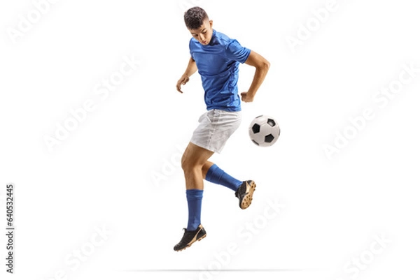 Fototapeta Football player kicking a ball with back heel
