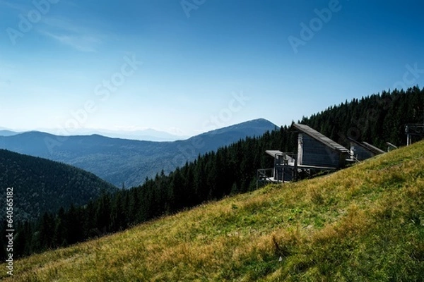 Fototapeta view of the mountains and a wooden house in the mountains