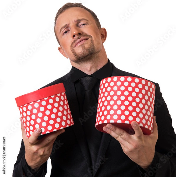 Obraz man hand holding a gift box in a gesture of giving.