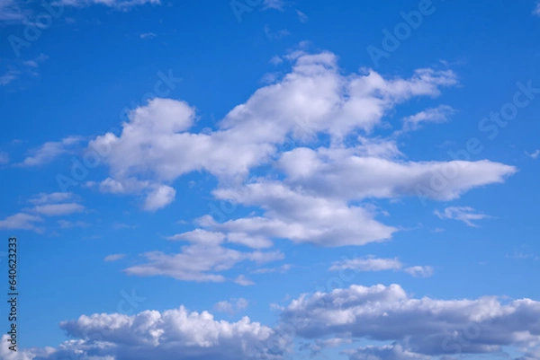Fototapeta Summer evening sky in the picturesque clouds, lit by the rays of the setting sun.