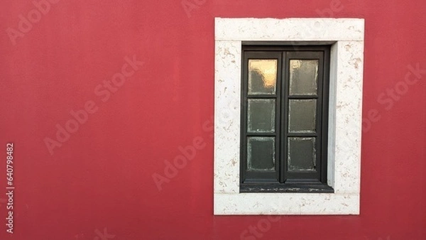 Fototapeta Wooden old window in an old castle with red walls and a stone window frame