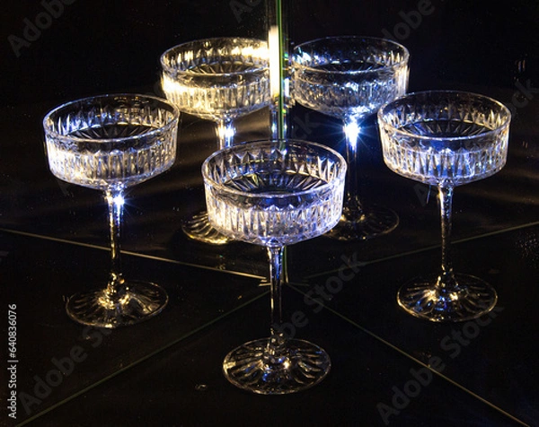 Obraz A glass of wine reflected in mirrors and illuminated by colored light