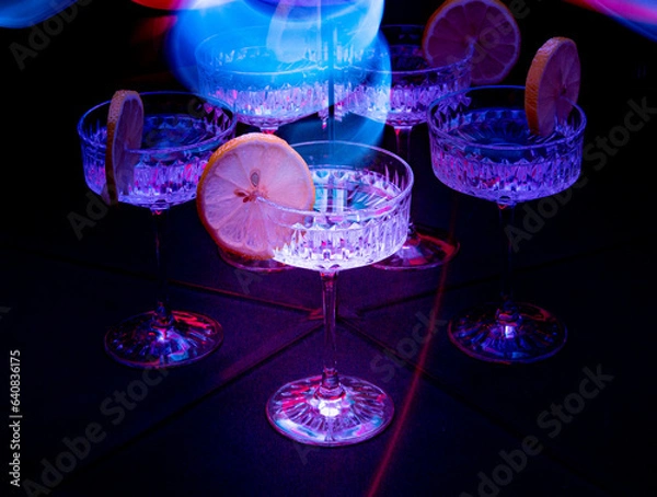Obraz A glass of wine reflected in mirrors and illuminated by colored light