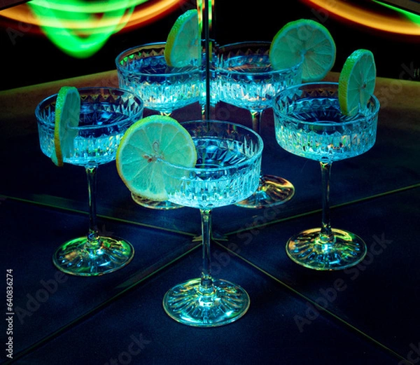 Obraz A glass of wine reflected in mirrors and illuminated by colored light