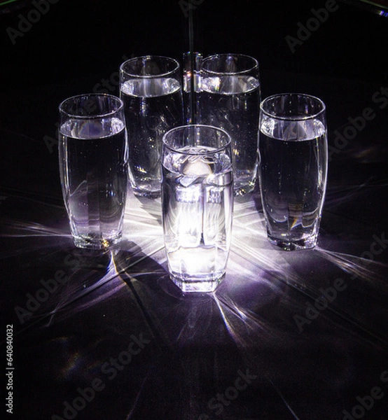 Obraz Glass glasses with water reflected in mirrors on a black background