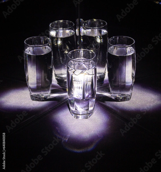 Obraz Glass glasses with water reflected in mirrors on a black background