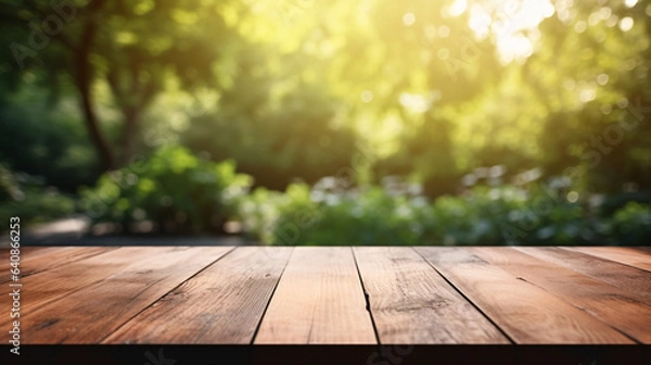 Fototapeta empty wooden table top with blur background of garden for product display