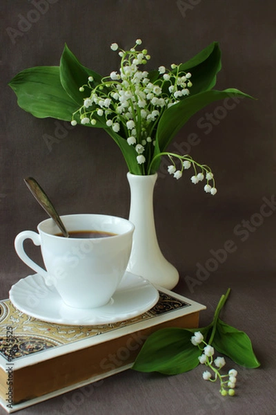 Obraz Bouquet of lilies of the valley, a book, a cup of coffee.