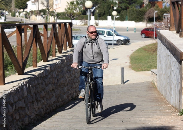 Obraz Elderly man on a bicycle.