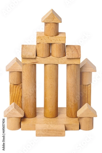 Obraz Wooden isolated house. Wooden toy castle constructed of cubes, cylinders, triangles and other shapes made of beech wood. Wooden toy blocks. Macro.