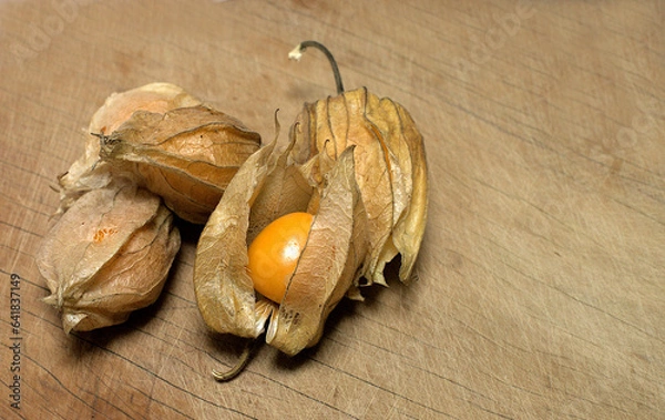 Obraz Fresh Aguaimanto fruit from Peru, with still in its leaves on a wooden table.