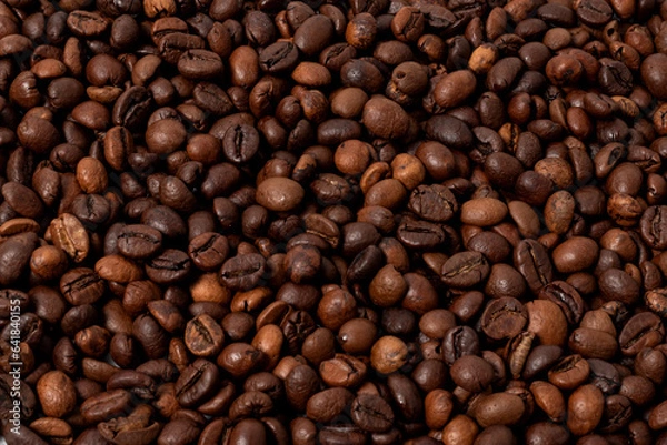 Fototapeta whole roasted coffee beans in close-up as a background image
