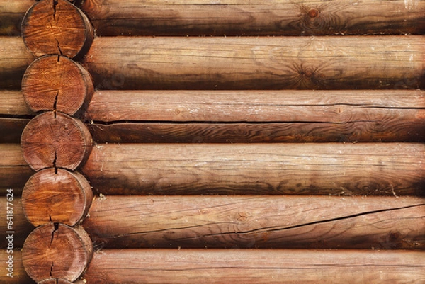 Fototapeta A log wall construction with a swedish cope log profile. Dirty and heavily cracked wall of a blockhouse as a background