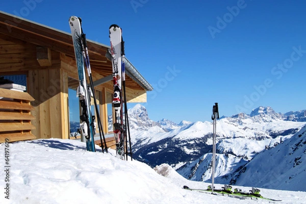 Fototapeta Skis next to the hut in high mountains at sunny day