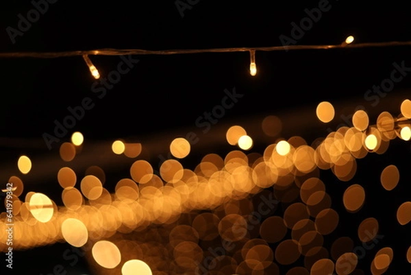 Fototapeta Blurred golden festive lights. Blurred backdrop for holidays and parties. Christmas Party concept.